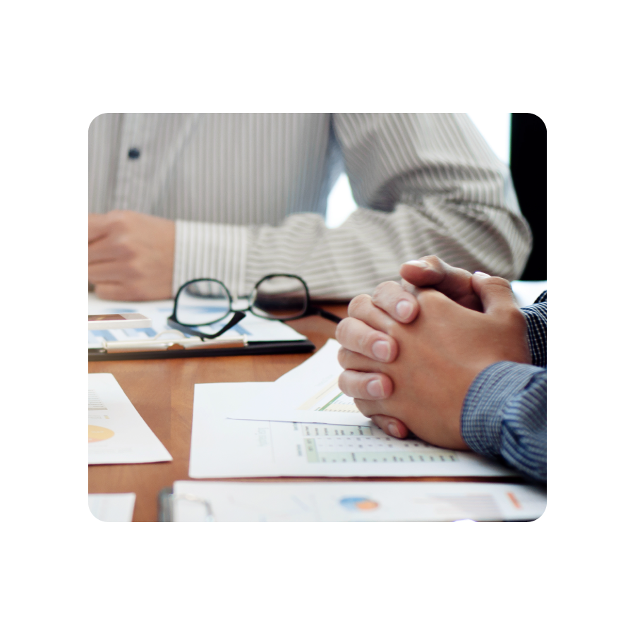 Hands of two people working together at table