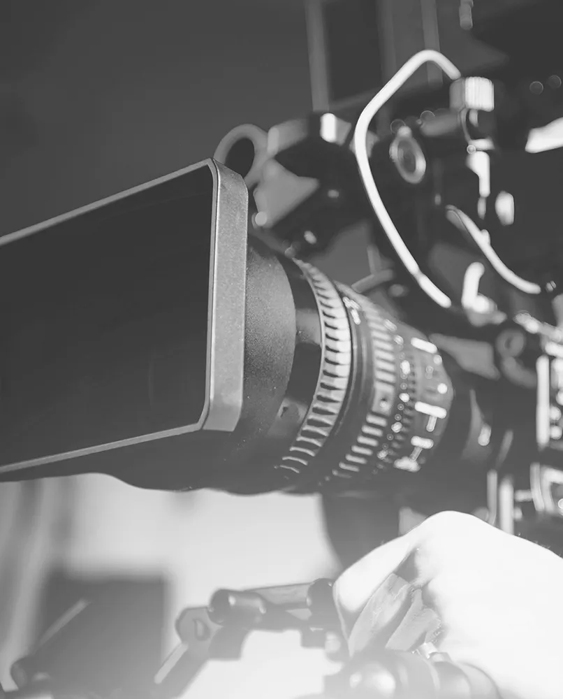 Film camera with camerman's hand on controls
