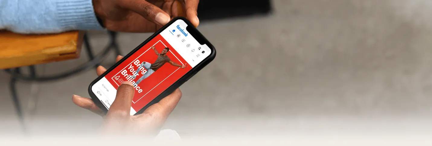 Man holding phone with TWD website on screen